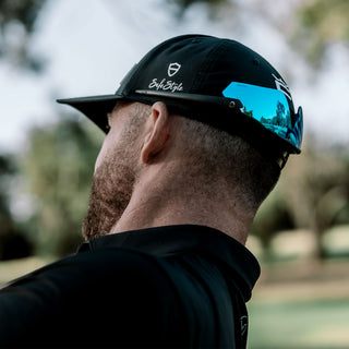 Matte black Phantoms safety glasses with blue lenses, worn on a person's face, full-face view