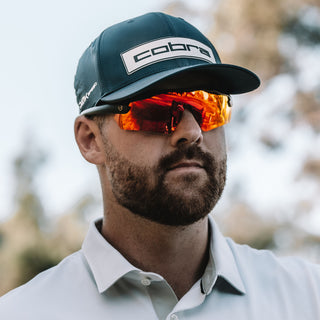 Matte black Phantoms safety glasses with red lenses, worn on a person's face, frontal view