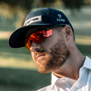 Matte black Phantoms safety glasses with red lenses, worn on a person's face, frontal view