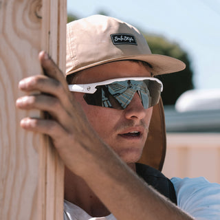 Phantoms Matte White safety glasses on a person's face, frontal view, polarised lenses visible
